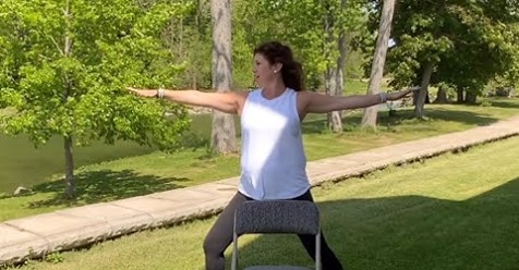 Woman holding a yoga pose outdoors