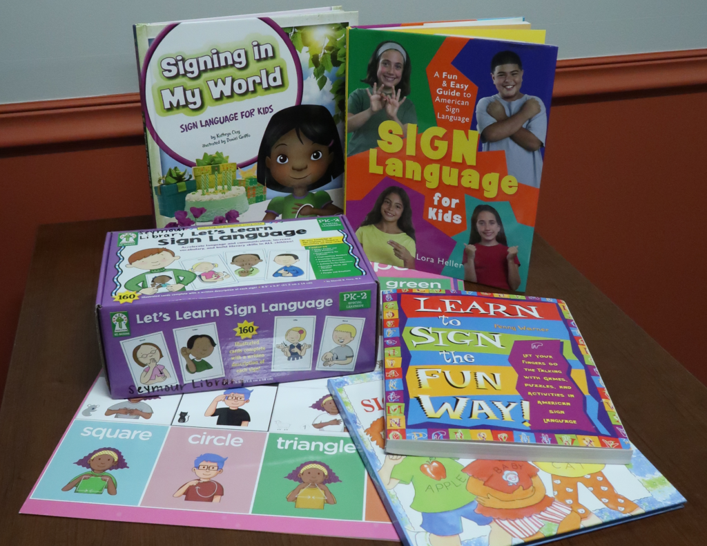 American Sign Language - Learning Backpack as Seymour Library. Image of a variety of books, games and activities to learn ASL.