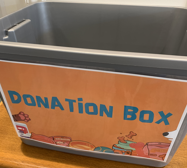 SPCA Donation Box at Seymour Library -- featuring a grey tote with a donation box sign taped on the exterior.